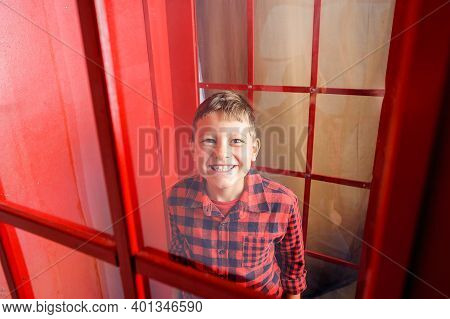 Cheerful Caucasian Boy In Winter Clothes Dressed A Snowball Maker On His Head And Smiling In A Winte