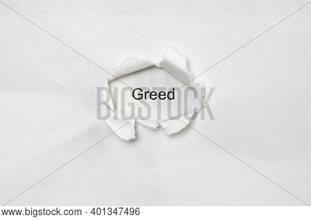 Word Greed On White Isolated Background, The Inscription Through The Wound Hole In Paper. Concept Of