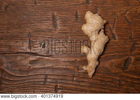 Close Up Of Fresh Ginger Root On Wooden Table
