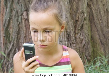 Preteen flicka med mobiltelefon