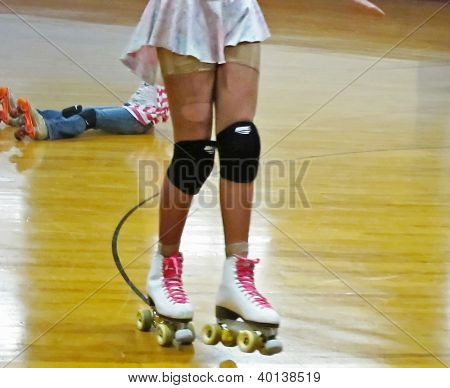 Young Girl Roller Skating With Knee Pads