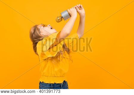 Portrait Of Young Caucaian Girl With Long Fair Hair In Yellow Glasses Smiles And Sings Songs With A 
