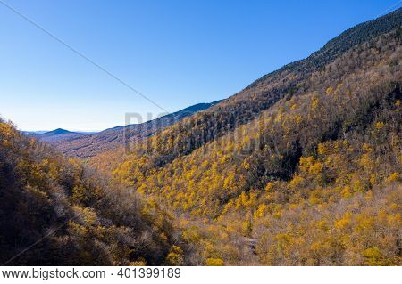 Panoramic View Of Late Fall Foliage In Smugglers Notch, Vermont.