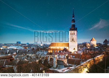 Tallinn, Estonia. Night Starry Sky Above Traditional Old Architecture Skyline In Old Town. St. Nicho