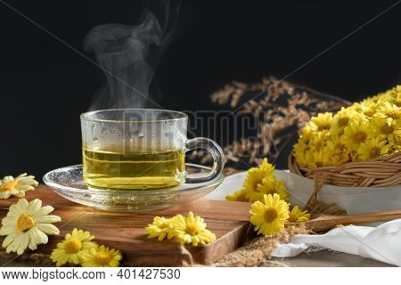 Chrysanthemum Tea With Hot Steam And Chrysanthemum Flower In Basket On Black Background. Healthy Bev