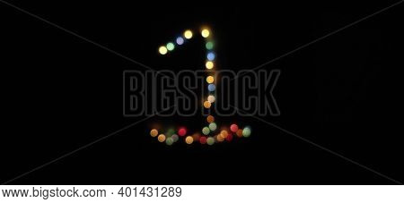 Number One (1) Made With Multicolored Christmas Lights . Blurred Bokeh Abstract Isolated On A Black 