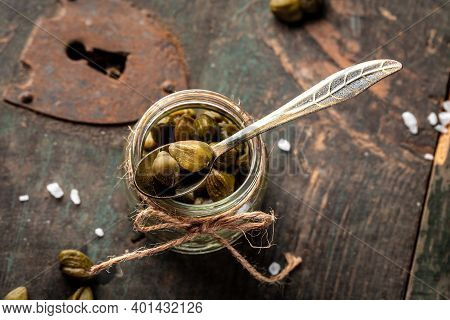 Capers On Wooden Background. Edible Flower Buds Of Capparis Spinosa, Caper Bush Or Flinders Rose. Cl