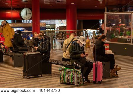 Prague, Czech Republic, 12-31-2020. People Are Sitting Looking At The Phones Waiting Their Train To 
