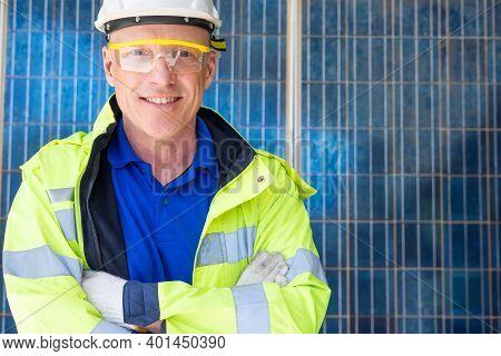 Outdoor Shot Of Caucasian Engineer Inspect Electrical Solar Panel Wearing Hardhat , Protective Eyegl