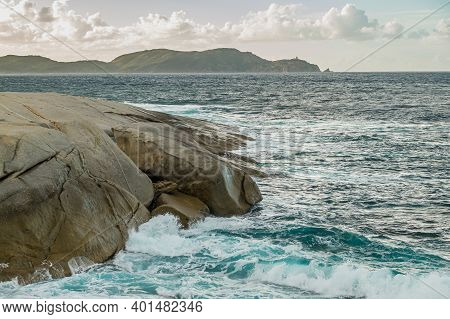 Stormy Mediterranean Sea Crashing Onto The Rocky Coastline At Punta Caldanu In The Balagne Region Of