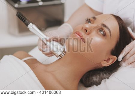 Beautiful Woman Getting Microcurrent Therapy Session For Her Neck And Face Skin. Attractive Woman Sm
