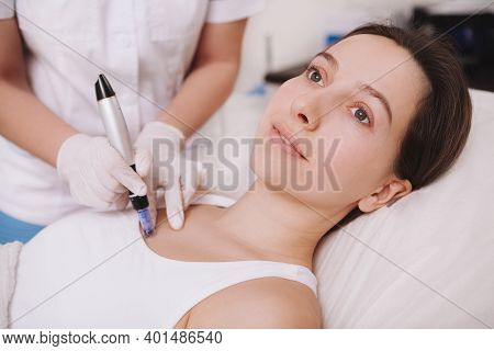 Cropped Shot Of A Professional Cosmetologist Doing Microinjections Into Skin Of Female Client, Using