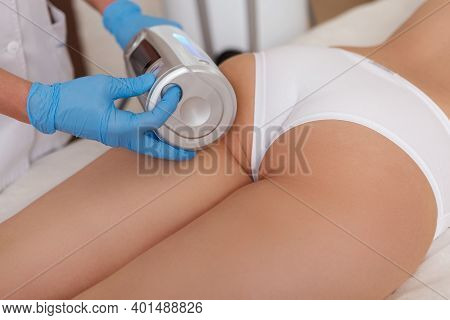 Cropped Close Up Of A Beautician Massaging Buttocks Of A Female Client, Using Endospheres Massage Ap