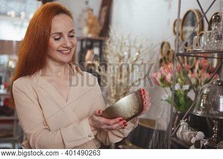 Beautiful Mature Red Haired Woman Smiling Joyfully, Shopping For Dishes At Kitchenware Store, Copy S