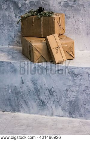Holiday Delivery Boxes, Parcels Wrapped In Brown Paper, Decorated And Tied With Rough Twine, Stone B