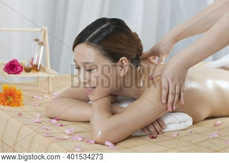 A Young Woman Enjoy Massage High Quality Photo