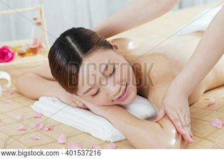 A Young Woman Enjoy Massage High Quality Photo