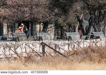 Etosha National Park, Namibia - June 13, 2012: Tourists At The Waterhole Viewpoint At Okaukeujo Rest