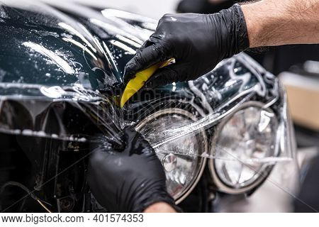Car Detailing Studio Wrapper Applying Protective Transparent Foil