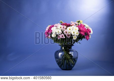 Clorfull Flowers Bouquet On Blue Background Studio Shot