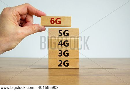 6g Network Evolution Symbol. Hand Holding A Wooden Block With 6g Symbol. 2g, 3g, 4g, 5g Words. Copy 
