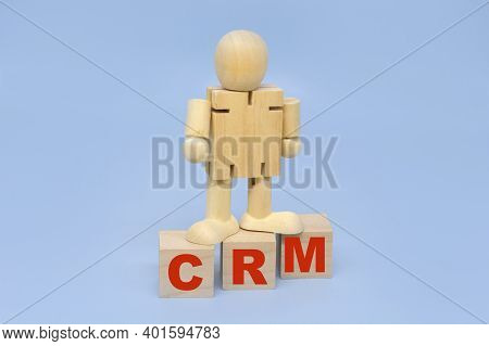 Crm Letters On Wooden Blocks And A Wooden Figure Of A Man. Business Concepts