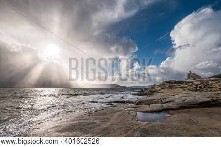Sun Rays Burst Through Storm Clouds Over Calvi In The Balagne Region Of Corsica With The Rocky Medit