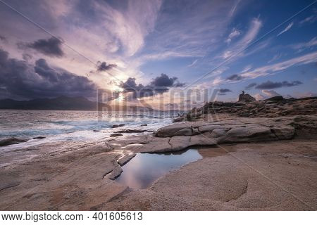 Waves Washing Onto The Rocky Coastline At Punta Caldanu Near Lumio In The Balagne Region Of Corsica 
