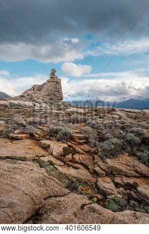 Ancient Genoese Tower At Punta Caldanu Near Lumio In The Balagne Region Of Corsica With The Snow Cap
