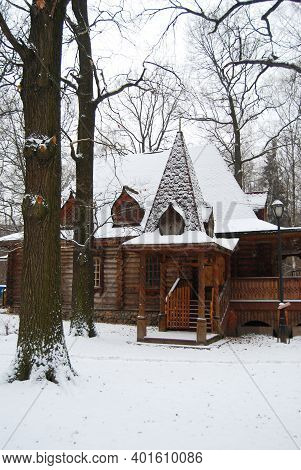 The Wooden House In Village. Winter. Near A Porch Cats Sit