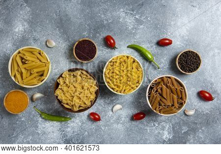 Different Types Of Raw Macaroni And Vegetables