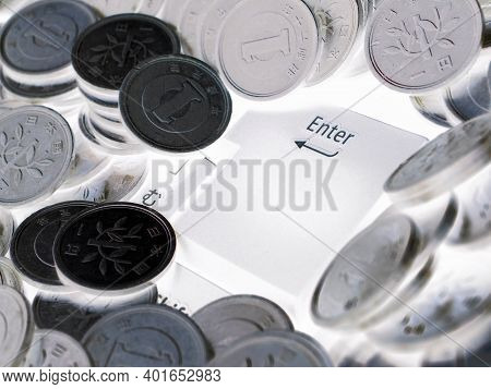 Japanese Money And Enter Button Close-up. 1 Yen Coins Are On The Keyboard Of A Computer Or Laptop. I
