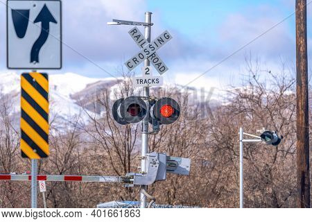 Grade Crossing Signal With Red Light Gate And Crossbuck At Railroad Crossing
