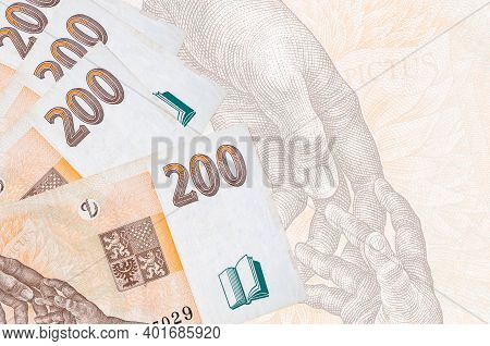 200 Czech Korun Bills Lies In Stack On Background Of Big Semi-transparent Banknote. Abstract Busines