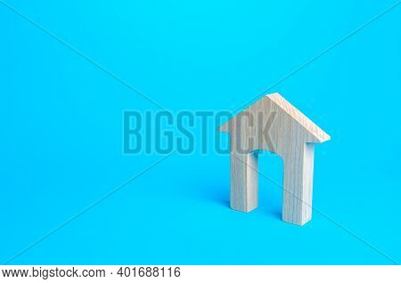 Wooden House Figure On A Blue Background. Affordable Comfortable Housing Concept, New Home. Mortgage