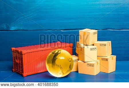 Planet Earth Globe Near A Cargo Container And Boxes. World Trade In Goods. Economic Ties. Production