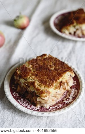Apple And Cheese Cobbler Crisp. Cobbler Or Crumble Dessert With Apples On Plates On Beige Linen Tabl