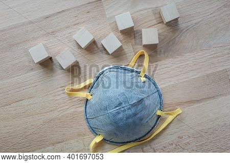 N95 Mask On The Wooden Table With Group Of Wooden Cube For Input Wording,helps Prevent Corona Virus 