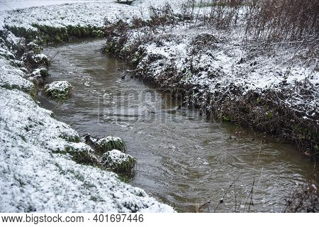 A Brook Bending Or Meandering Round To The Right In A Sowy Park In Uttoxeter England