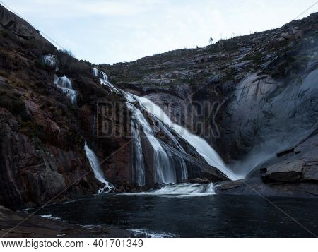 Long Exposure Of Cascada De Ezaro Waterfall Xallas Jallas River Flowing Down Rock In Dumbria La Coru