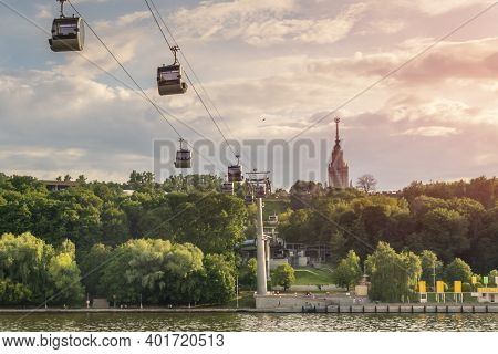 Cable Car Over Moscow River In Vorobyevy Gory Park With University Skyscraper Spire In Background. S