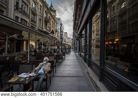 Belgrade, Serbia - May 12, 2020: Old Senior Man Wearing A Respiratory Face Mask Sittting At The Terr