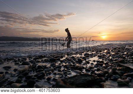 Banyuwangi, Indonesia - May 14, 2020 : A Woman Playing With The Dogs At Watudodol Beach Banyuwangi I