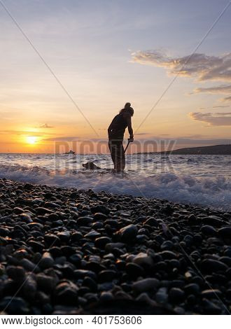 Banyuwangi, Indonesia - May 14, 2020 : A Woman Playing With The Dogs At Watudodol Beach Banyuwangi I