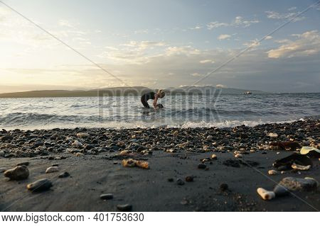 Banyuwangi, Indonesia - May 14, 2020 : A Woman Playing With The Dogs At Watudodol Beach Banyuwangi I
