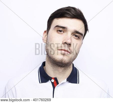 Portrait of young bearded sportsman looking into camera with disappointment and despair expression on his face. Close up of strong unhappy man with brown hair.