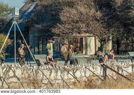 Etosha National Park, Namibia - June 13, 2012: Tourists At The Waterhole Viewpoint At Okaukeujo Rest