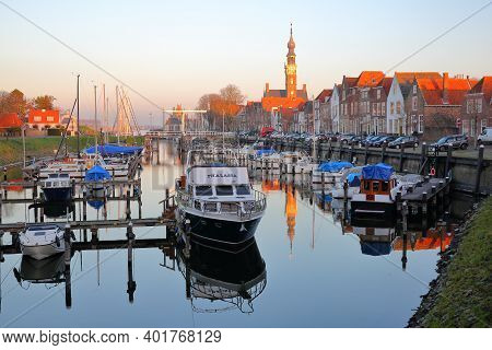 Veere, Netherlands - December 10, 2020: The Marina (harbor) And Historic Buildings With The Clock To