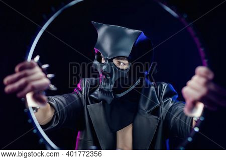 A Man Wearing A Demon Skull Mask In A Leather Cloak