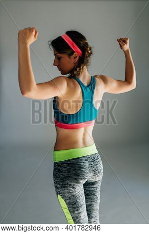 Profile Of A Fit Woman Flexing Her Muscles